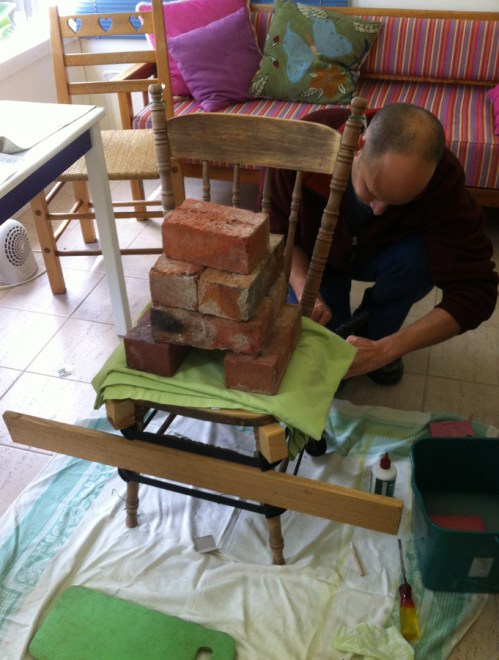 tightening the clamps on the bottom half of chair