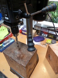 vertical drill press and wood block